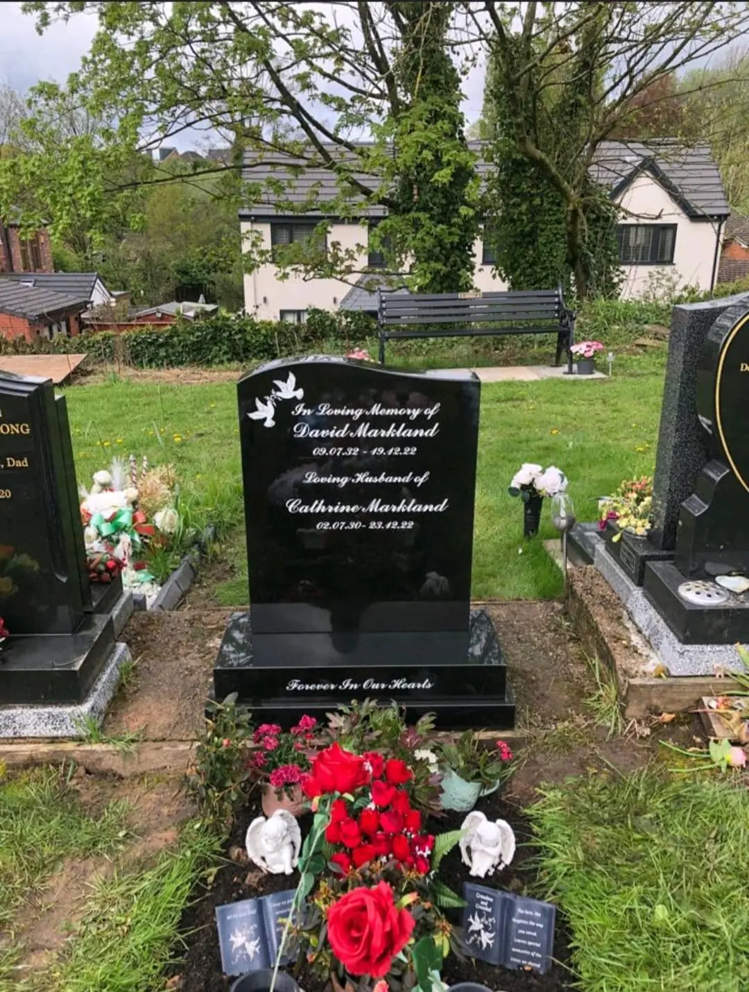 The Markland, an existing black memorial with white lettering and flowers